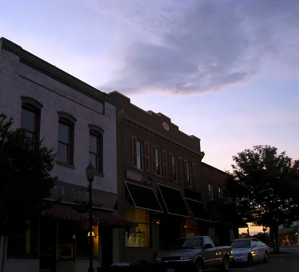 Brick storefronts in downtown Belmont at dusk